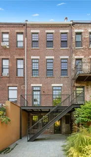 a view of a brick building with many windows