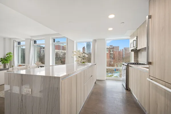 a large white kitchen with a large window