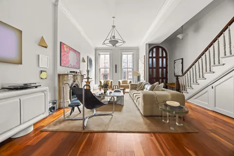 a living room with furniture a rug and white walls