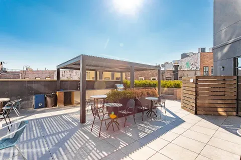 a view of a balcony with chairs and wooden floor