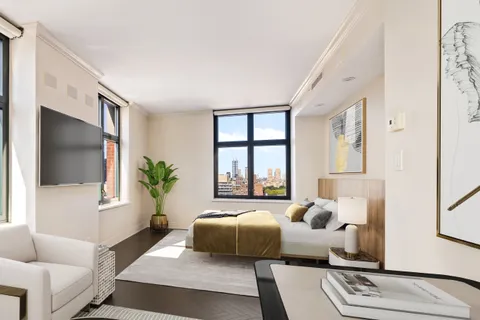 a bedroom with a large bed and a couch