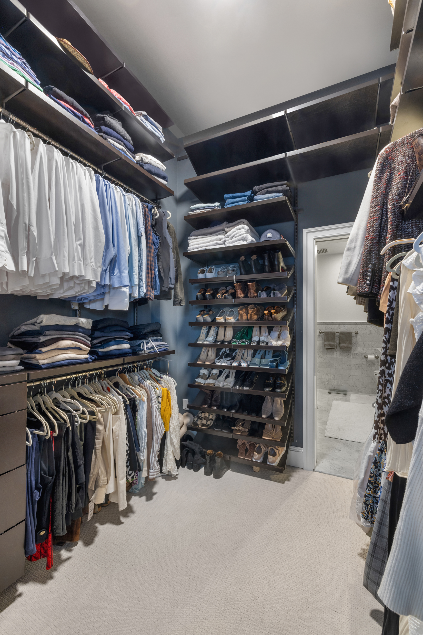 107 East 38th Street, Unit 2AB Manhattan, NY 10016 - Photo 6 of 13 a view of walk in closet with clothes and shoes