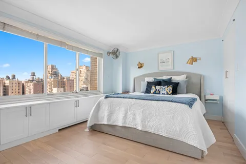 a bedroom with a large bed and a large window