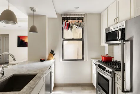 a kitchen with stainless steel appliances granite countertop a sink and a stove