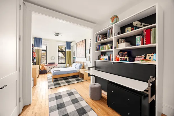 a living room with furniture and a book shelf