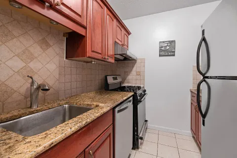 a kitchen with a sink a stove and a microwave oven