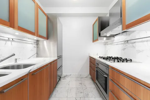 a kitchen with stainless steel appliances granite countertop a sink and a stove