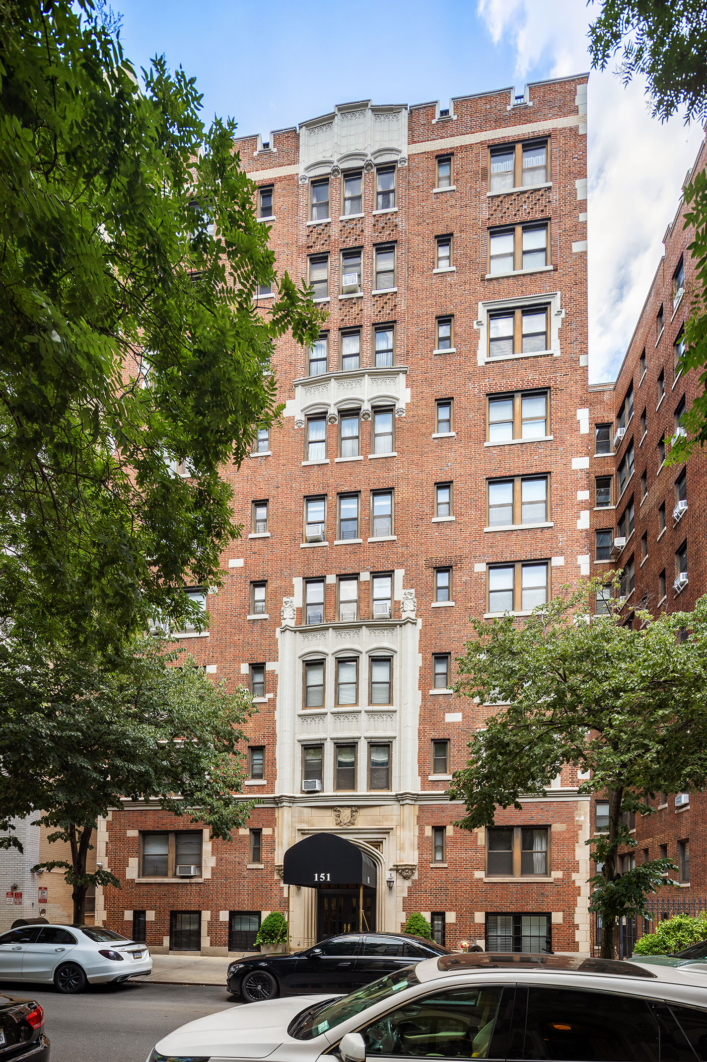 151 East 83rd Street, Unit 6D Manhattan, NY 10028 - Photo 13 of 14 a front view of a building with lot of trees