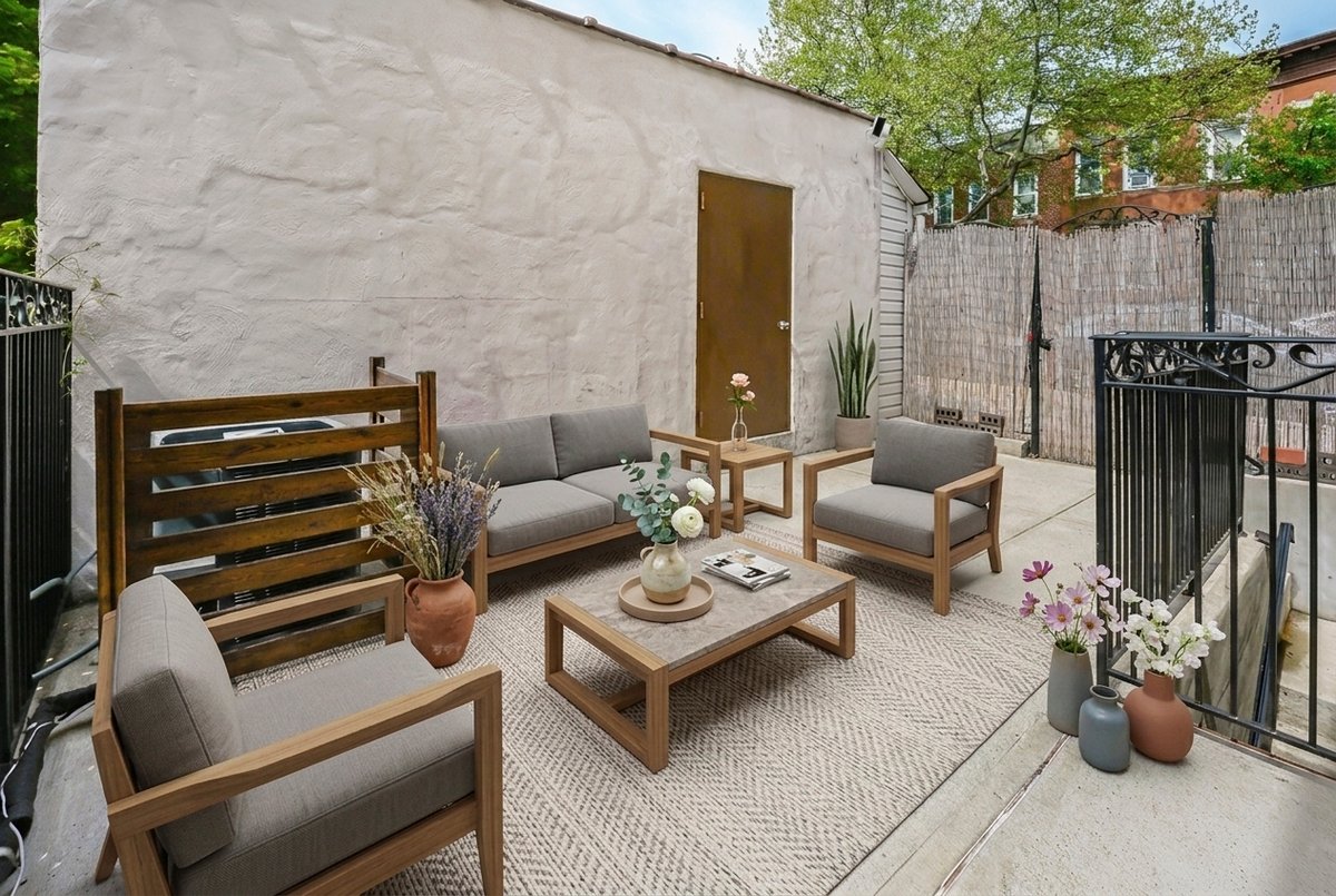 1702 11th Avenue Brooklyn, NY 11218 - Photo 19 of 25 a view of a patio with couches and a table and chairs with wooden fence