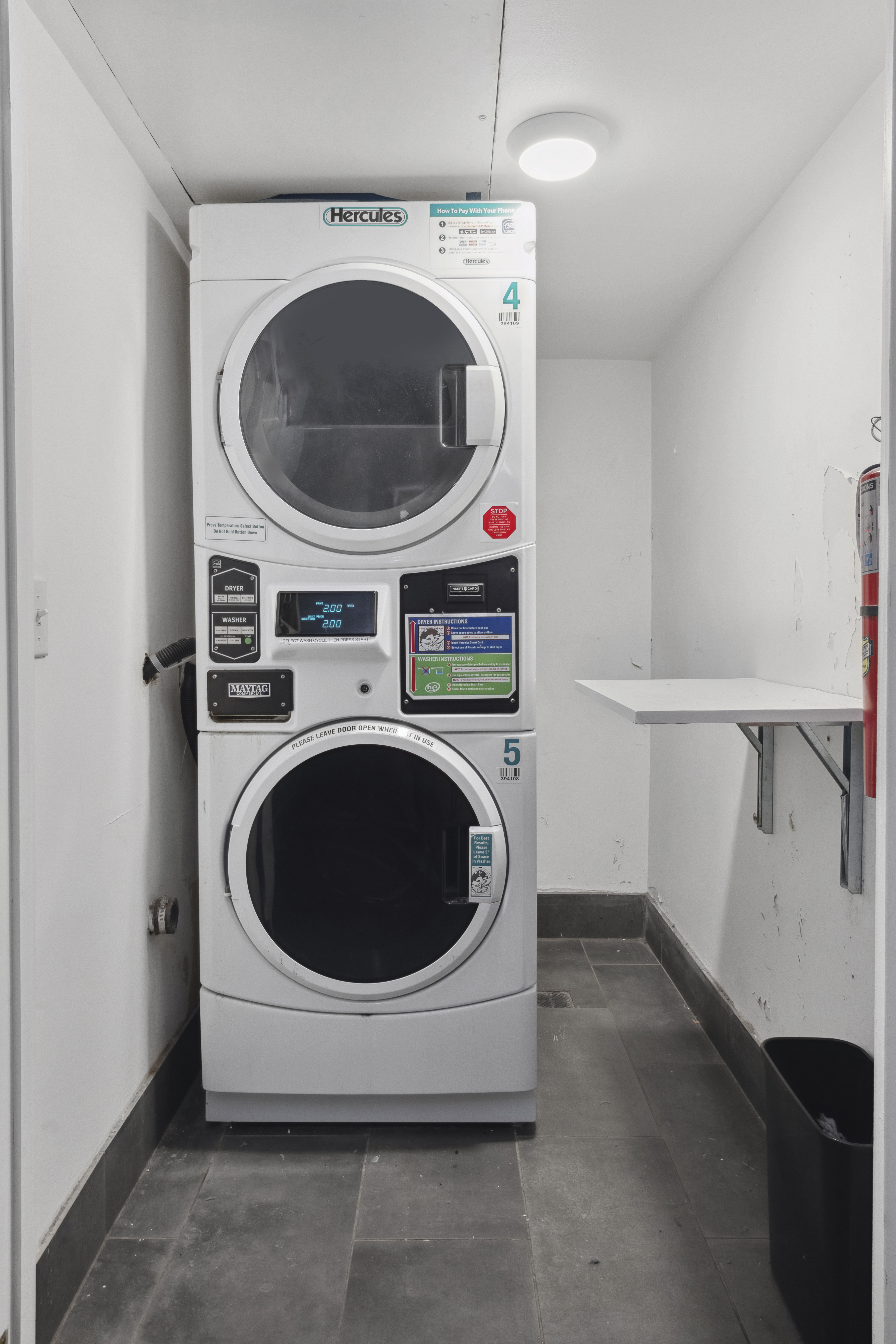 211 Thompson Street, Unit GLD Manhattan, NY 10012 - Photo 9 of 10 a utility room with dryer and washer