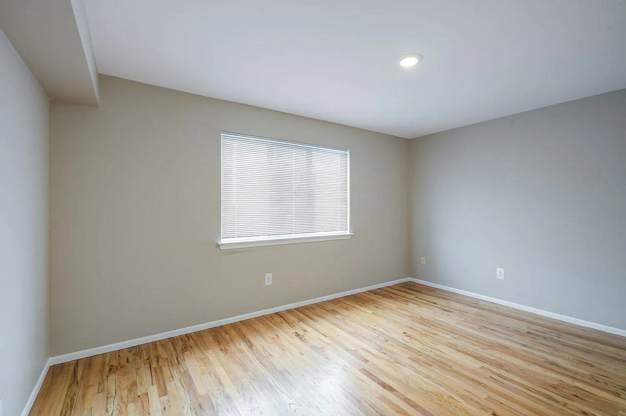 2817 Batchelder Street, Unit 1 Brooklyn, NY 11235 - Photo 3 of 4 an empty room with wooden floor and windows