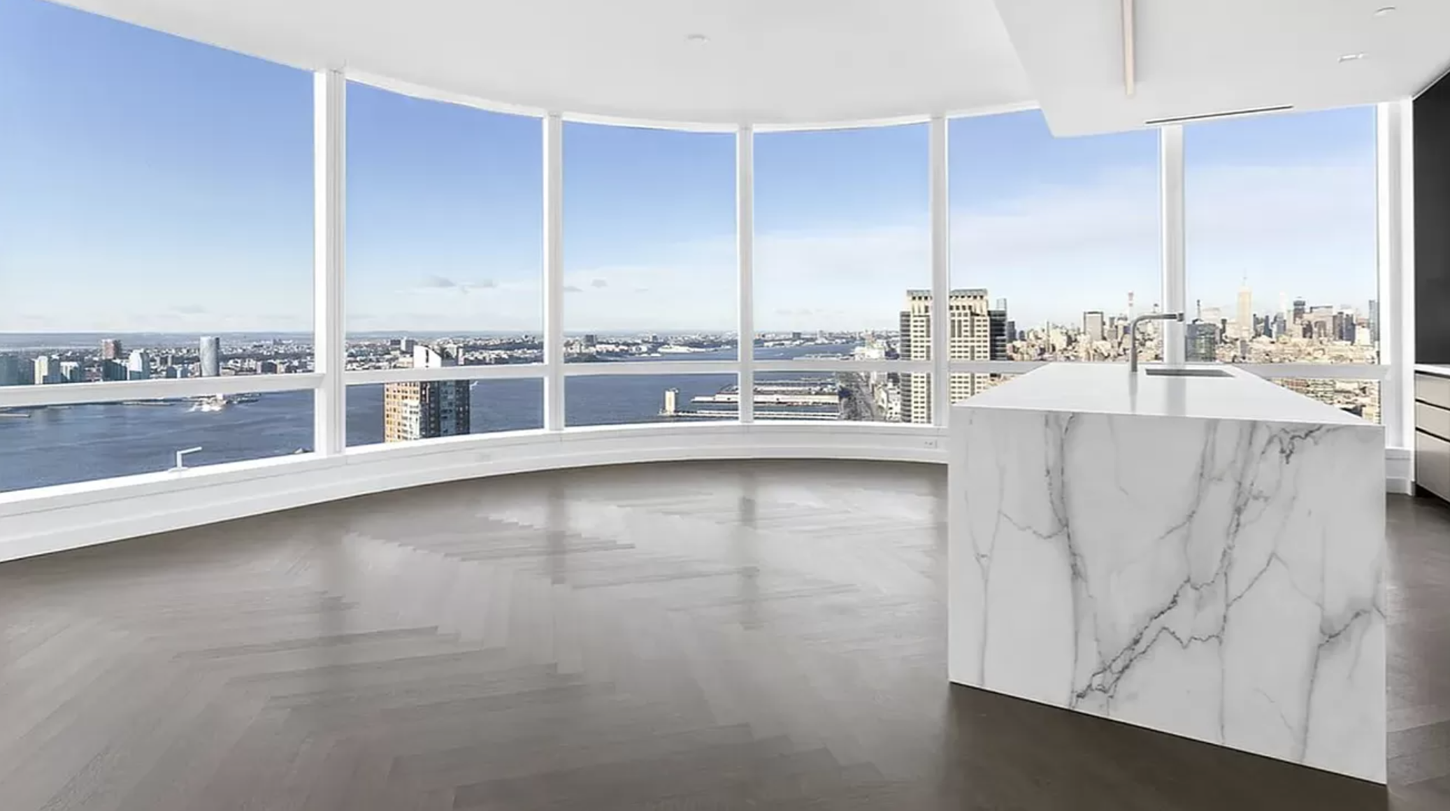 a view of a kitchen with kitchen island and a view of living room