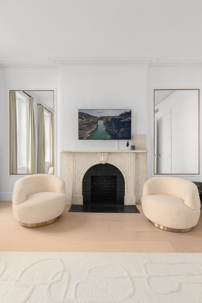 222 East 61st Street Manhattan, NY 10065 - Photo 10 of 28 a living room with furniture and a fireplace