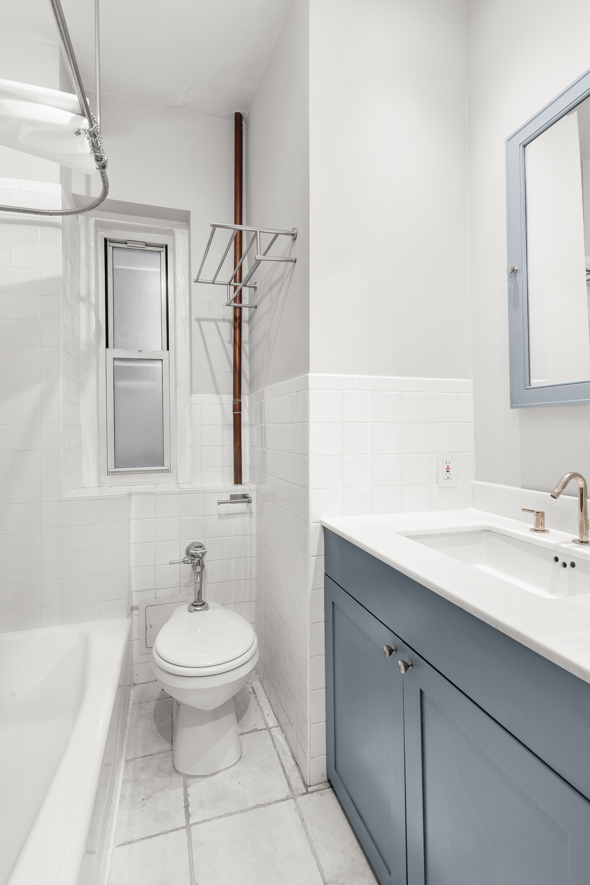 261 West 22nd Street, Unit 4 Manhattan, NY 10011 - Photo 6 of 8 a bathroom with a sink toilet and shower