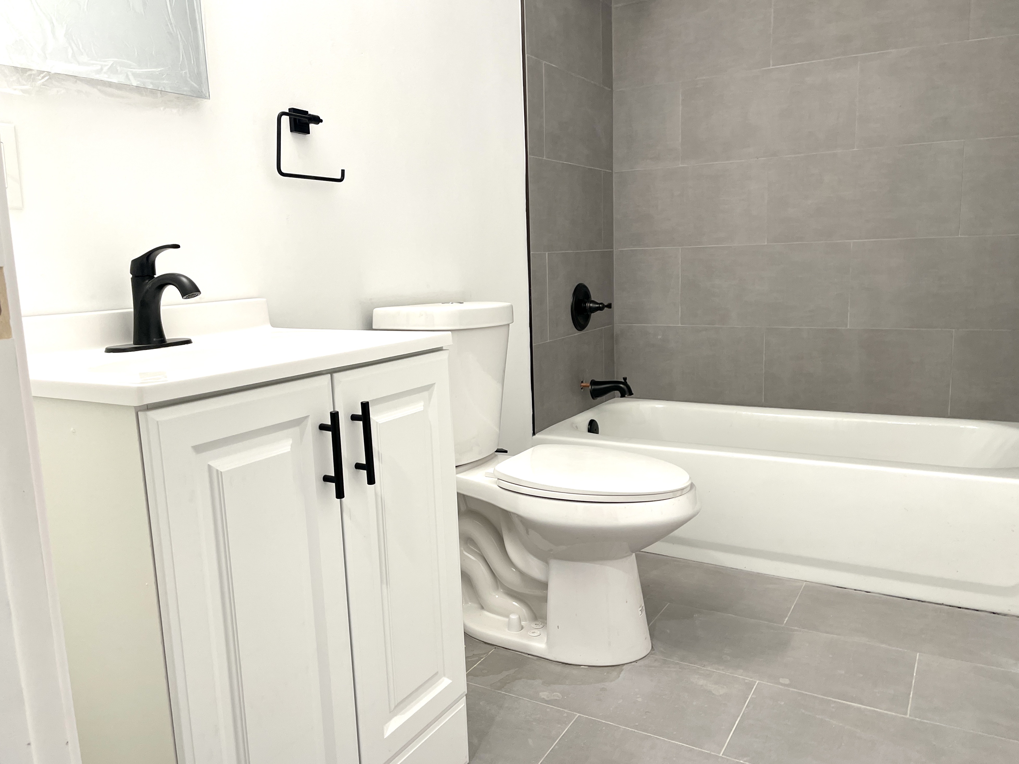 1999 3rd Avenue, Unit 1 Manhattan, NY 10029 - Photo 18 of 23 a bathroom with a toilet sink and shower