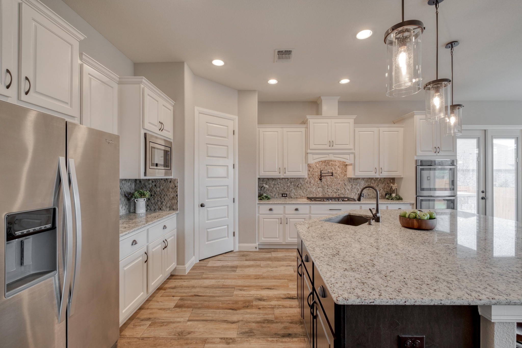 3836 Kyler Glen Road Round Rock, TX 78681 - Photo 11 of 41 a kitchen with stainless steel appliances granite countertop a sink refrigerator and cabinets