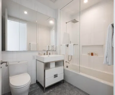 a bathroom with a toilet a sink and bathtub