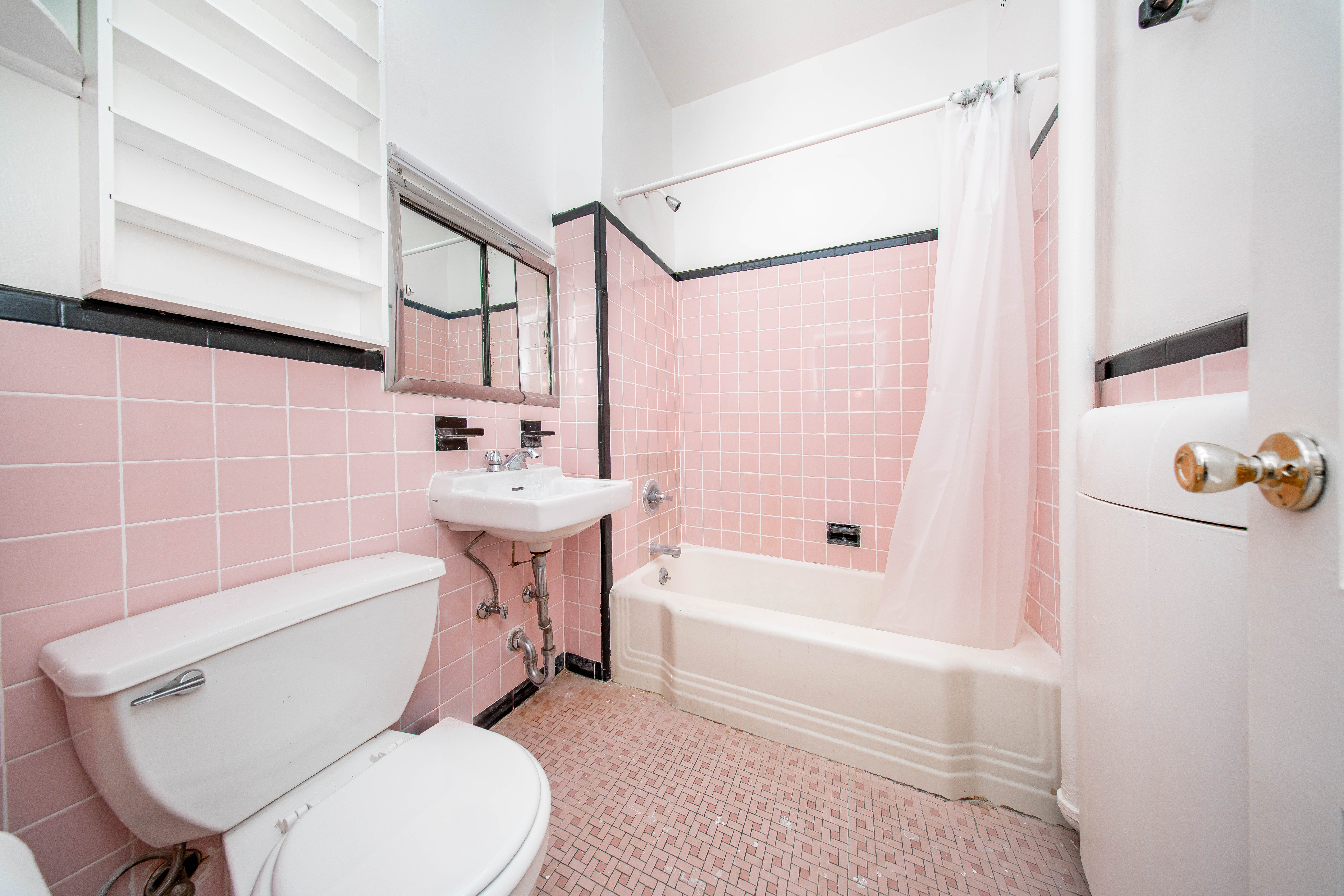 22-17 Astoria Boulevard, Unit 2W Queens, NY 11102 - Photo 10 of 10 a bathroom with a sink a toilet and bathtub