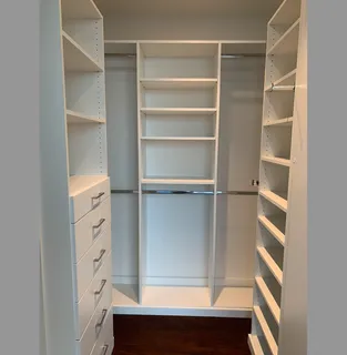 a view of walk in closet with empty racks