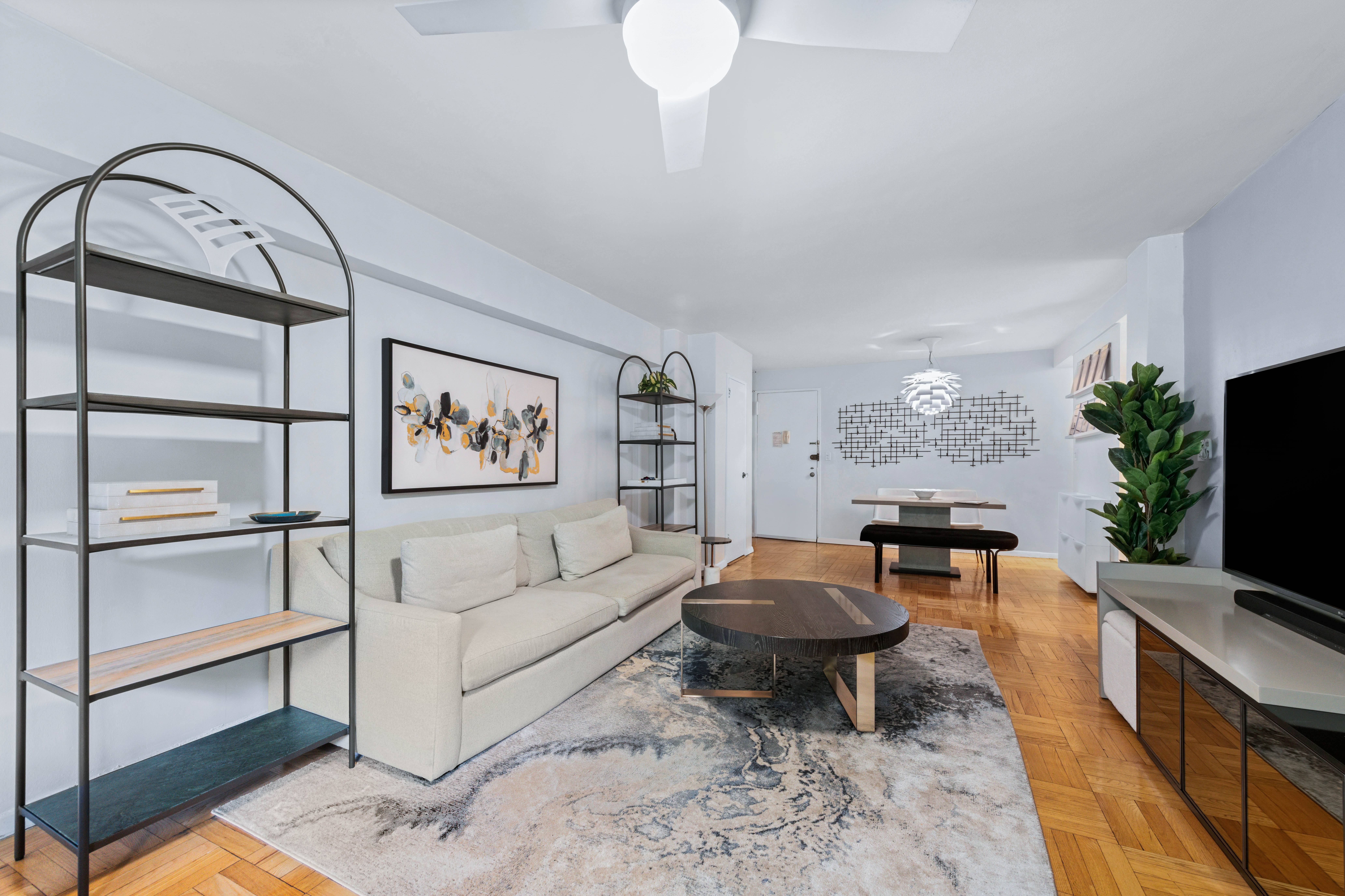 205 East 77th Street, Unit 4B Manhattan, NY 10075 - Photo 4 of 10 a living room with furniture a rug and a floor to ceiling window
