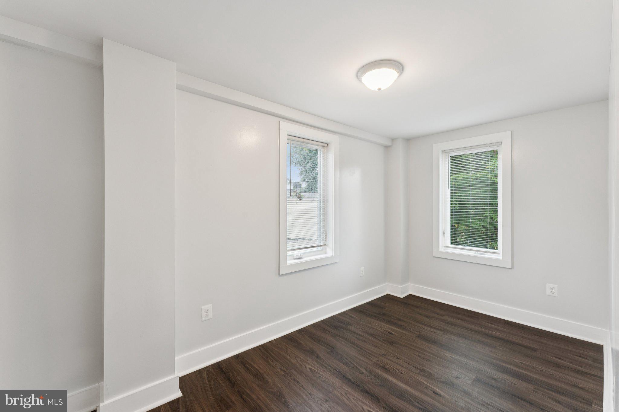 2822 28th Street Southeast Washington, DC 20020 - Photo 21 of 57 a view of an empty room with wooden floor and a window