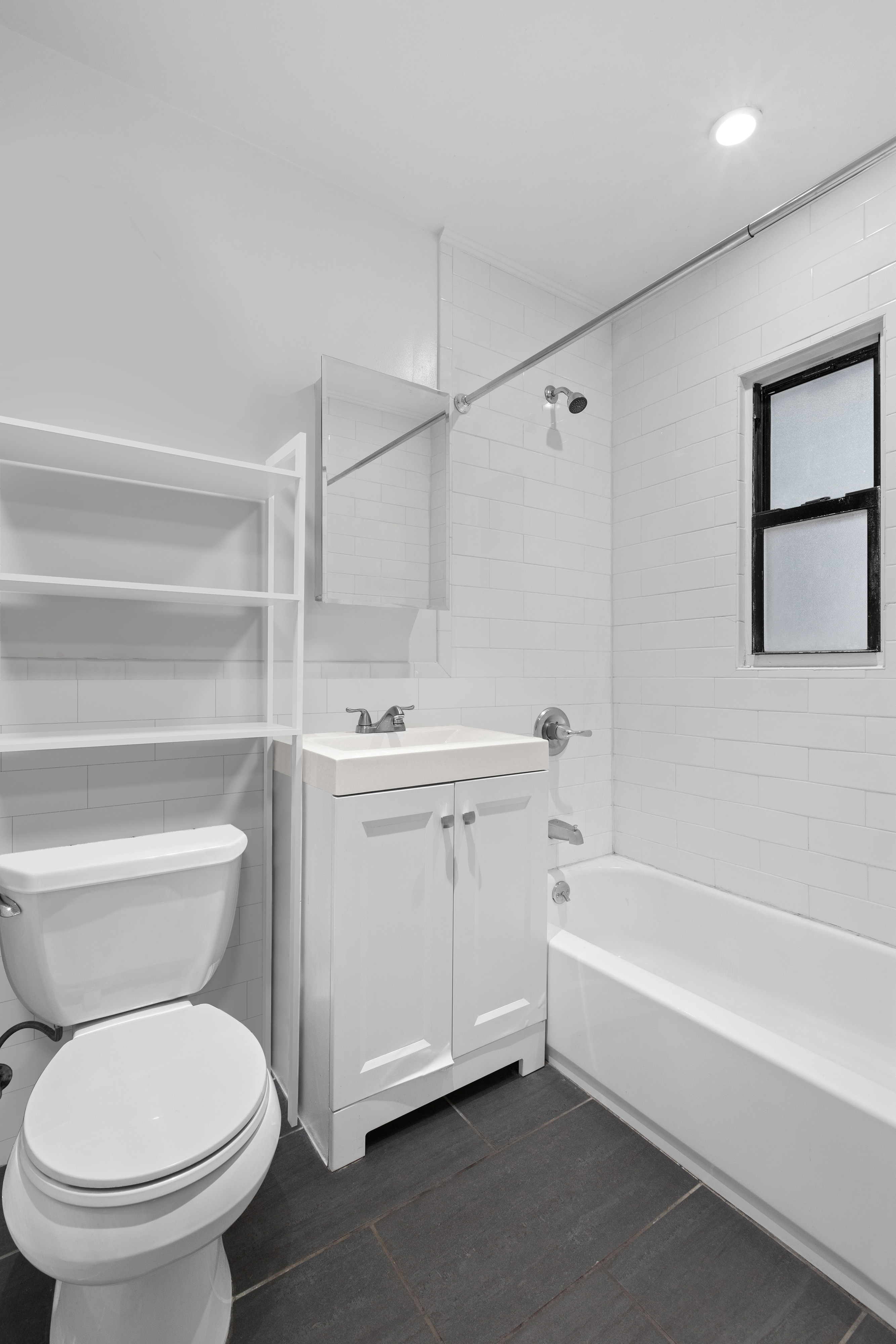 1582 York Avenue, Unit 2A Manhattan, NY 10028 - Photo 4 of 5 a bathroom with a toilet sink and bathtub