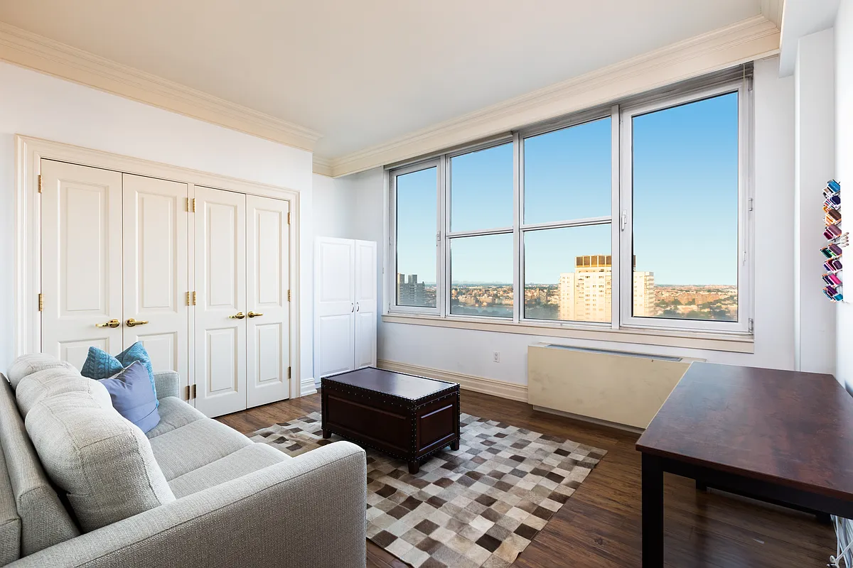 404 East 76th Street, Unit 30C Manhattan, NY 10021 - Photo 10 of 24 a living room with furniture and a window