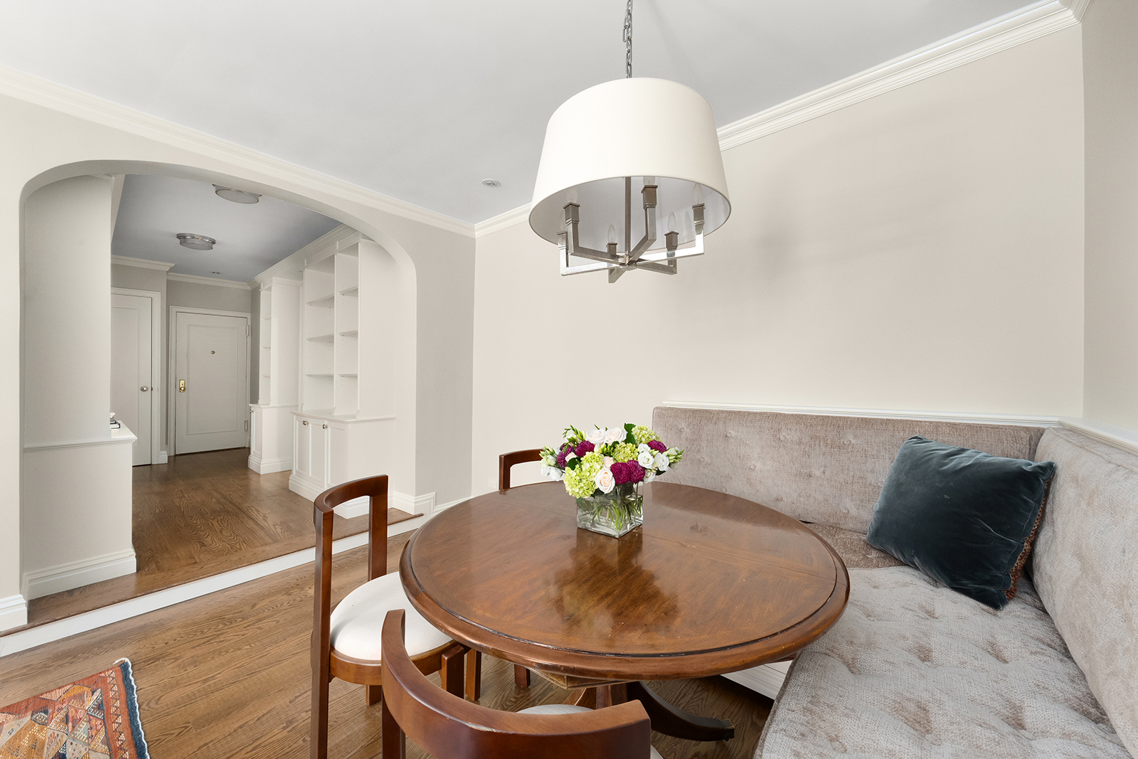 75 Bank Street, Unit 2H Manhattan, NY 10014 - Photo 4 of 18 a view of a dining room with furniture a chandelier and wooden floor