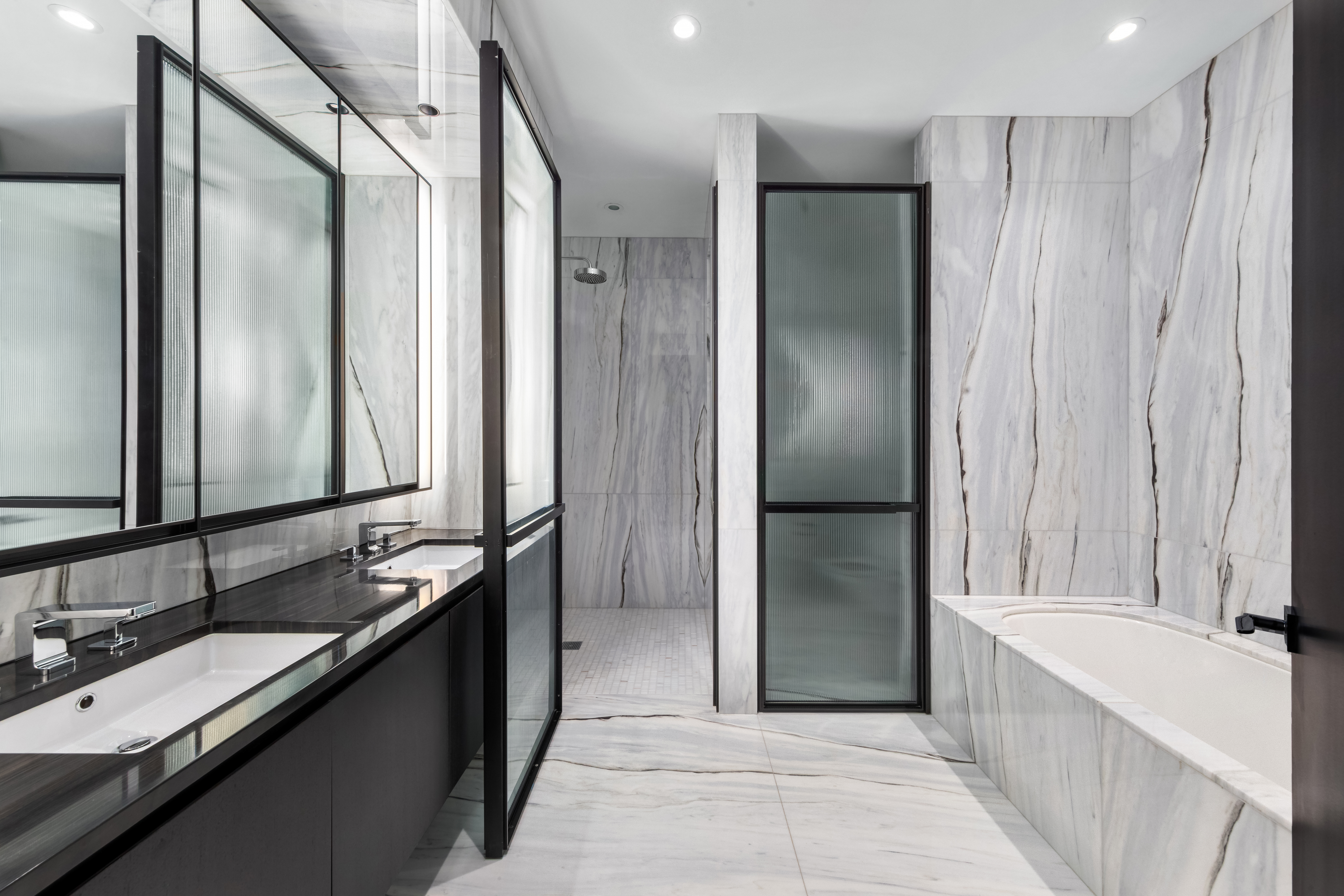 157 West 57th Street, Unit 50B Manhattan, NY 10019 - Photo 10 of 18 a bathroom with a double vanity sink and mirror with shower