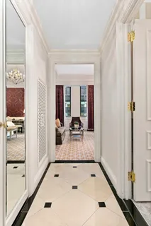 a very nice looking room with a large window and chandelier