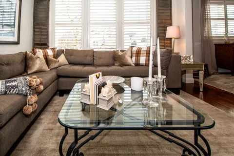 a living room with furniture a flat screen tv and a fireplace