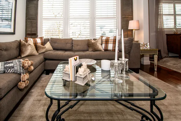 a living room with furniture a flat screen tv and a fireplace