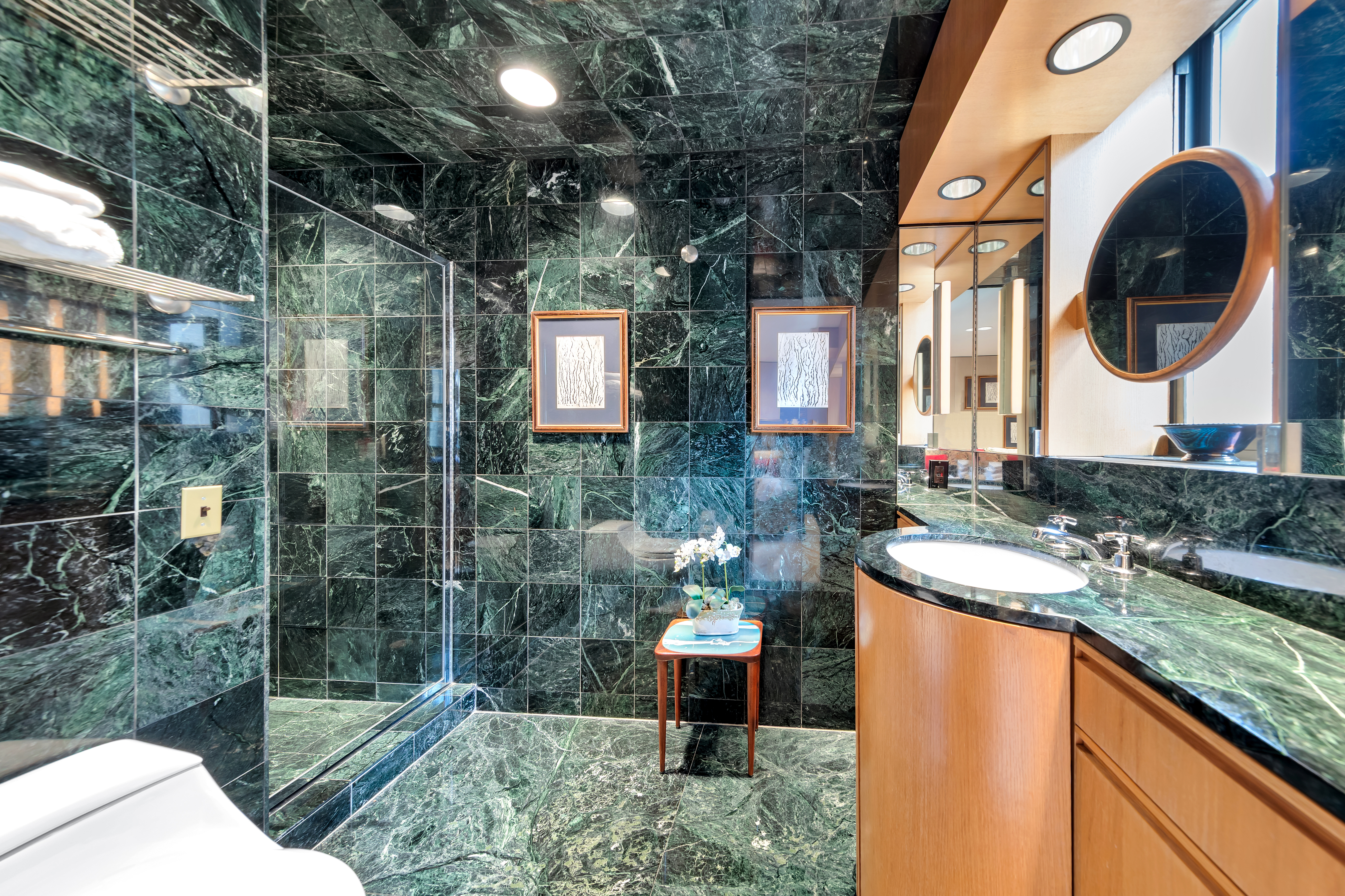 50 East 77th Street, Unit 8C Manhattan, NY 10075 - Photo 13 of 14 a bathroom with a sink and a mirror