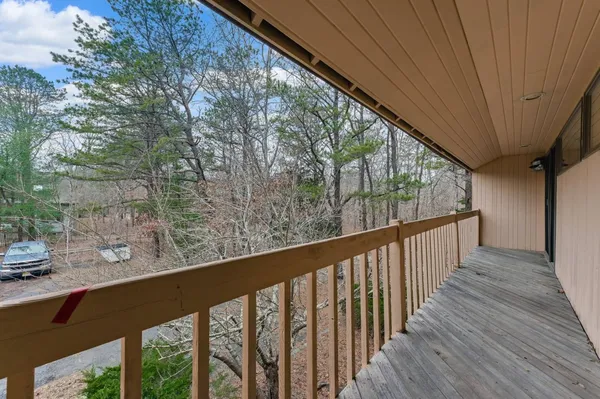 a view of balcony with wooden floor