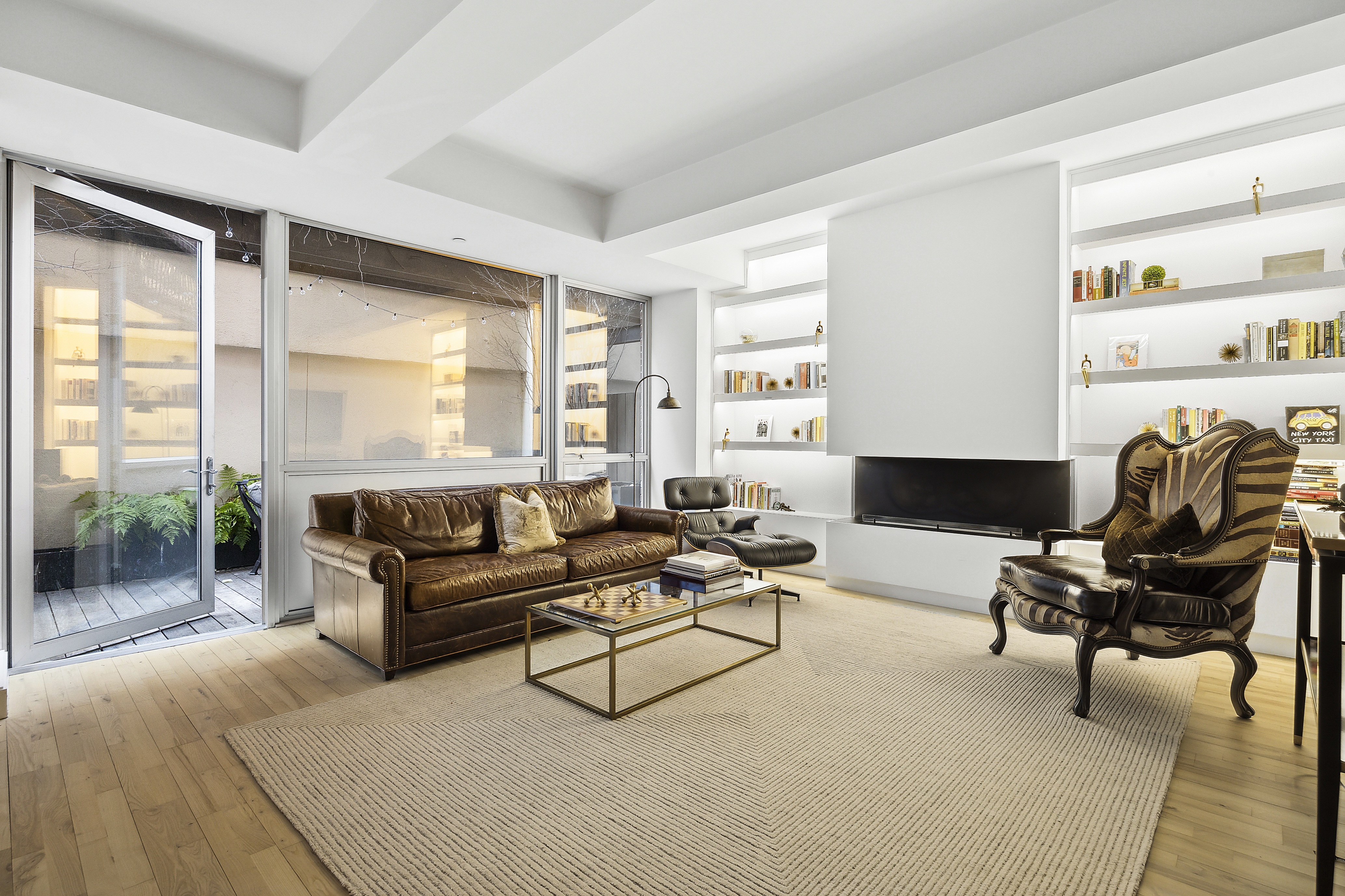 420 West 25th Street, Unit TH1E Manhattan, NY 10001 - Photo 10 of 22 a living room with furniture and a large window