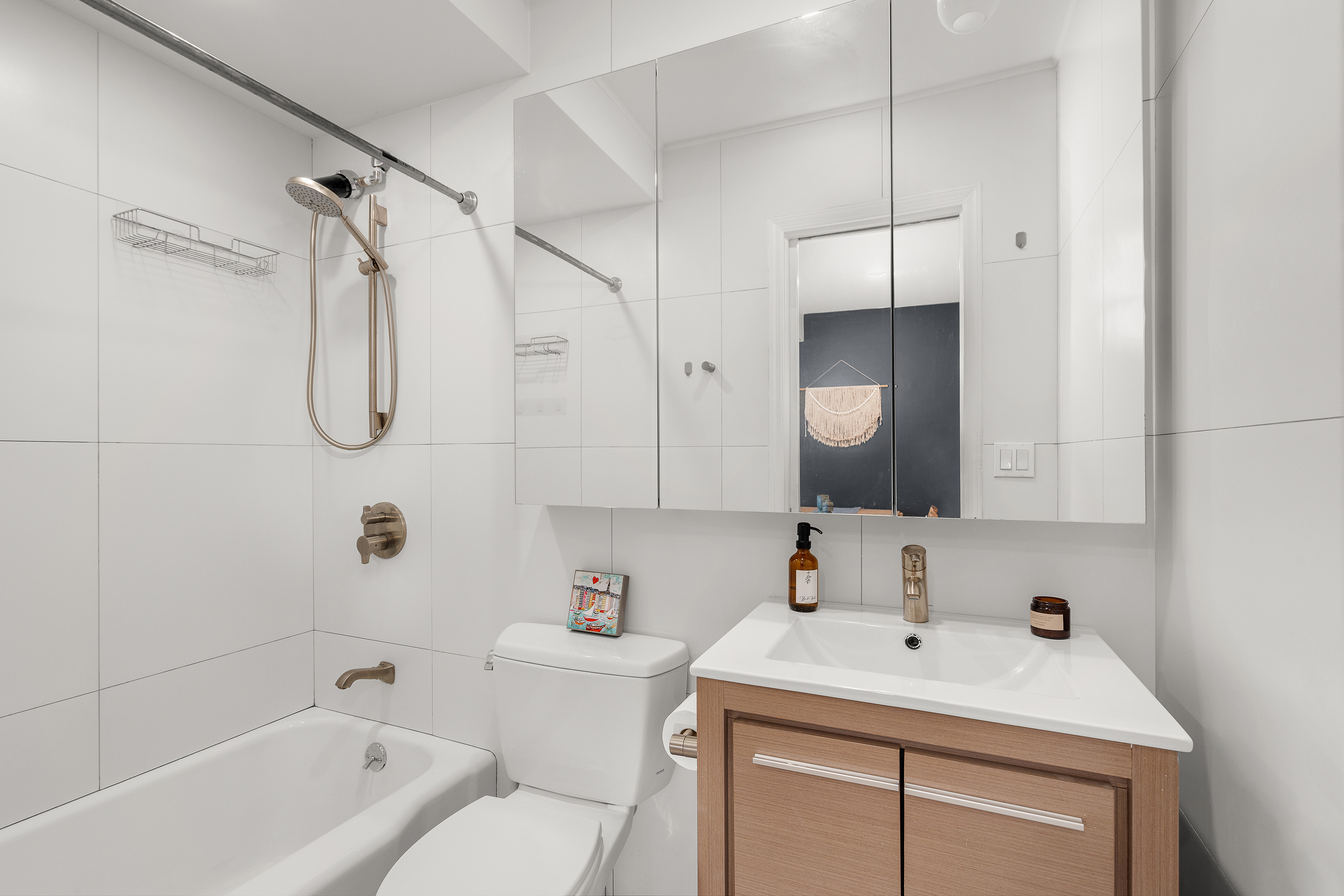 450 Clinton Street, Unit 4B Brooklyn, NY 11231 - Photo 5 of 7 a bathroom with a sink toilet vanity and shower