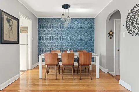 a view of a dining room with furniture and wooden floor