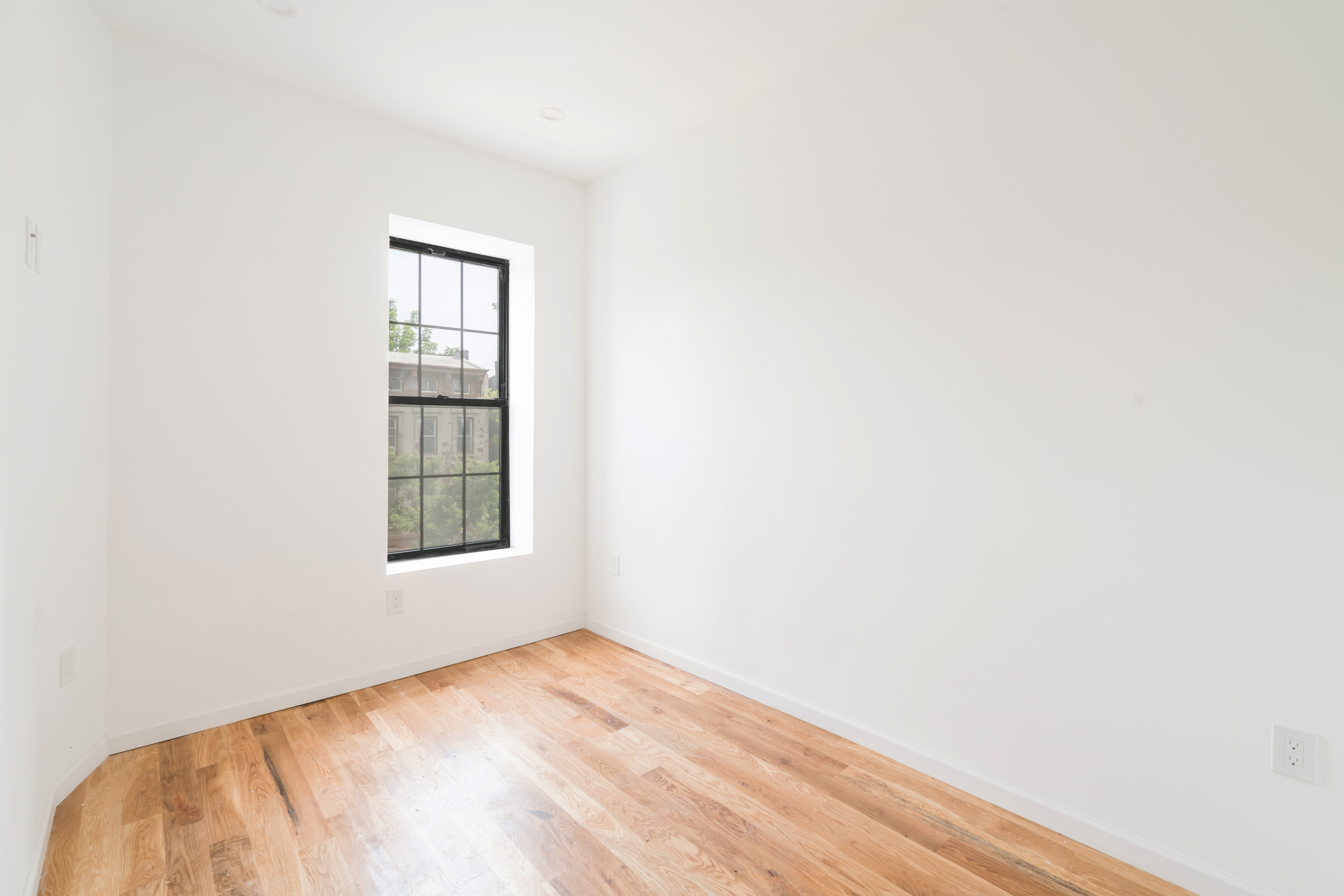 885 Lafayette Avenue, Unit 3 Brooklyn, NY 11221 - Photo 5 of 8 a view of empty room with wooden floor