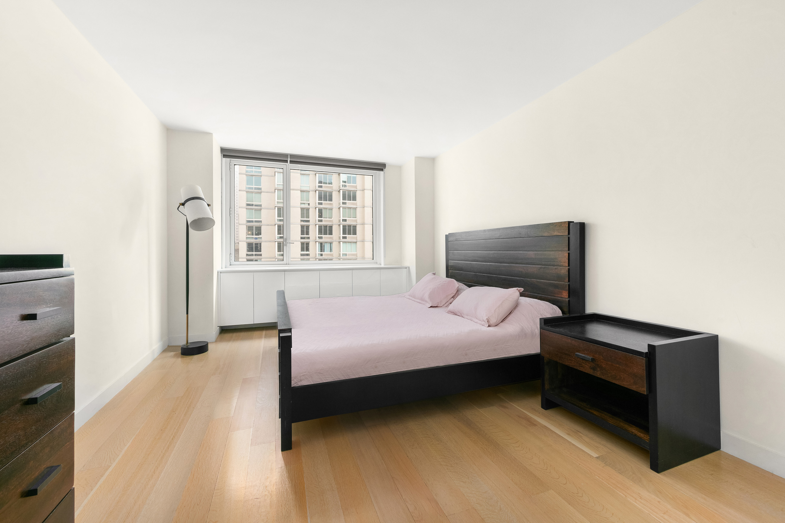 301 West 53rd Street, Unit 19F Manhattan, NY 10019 - Photo 3 of 8 a bedroom with a bed and a window