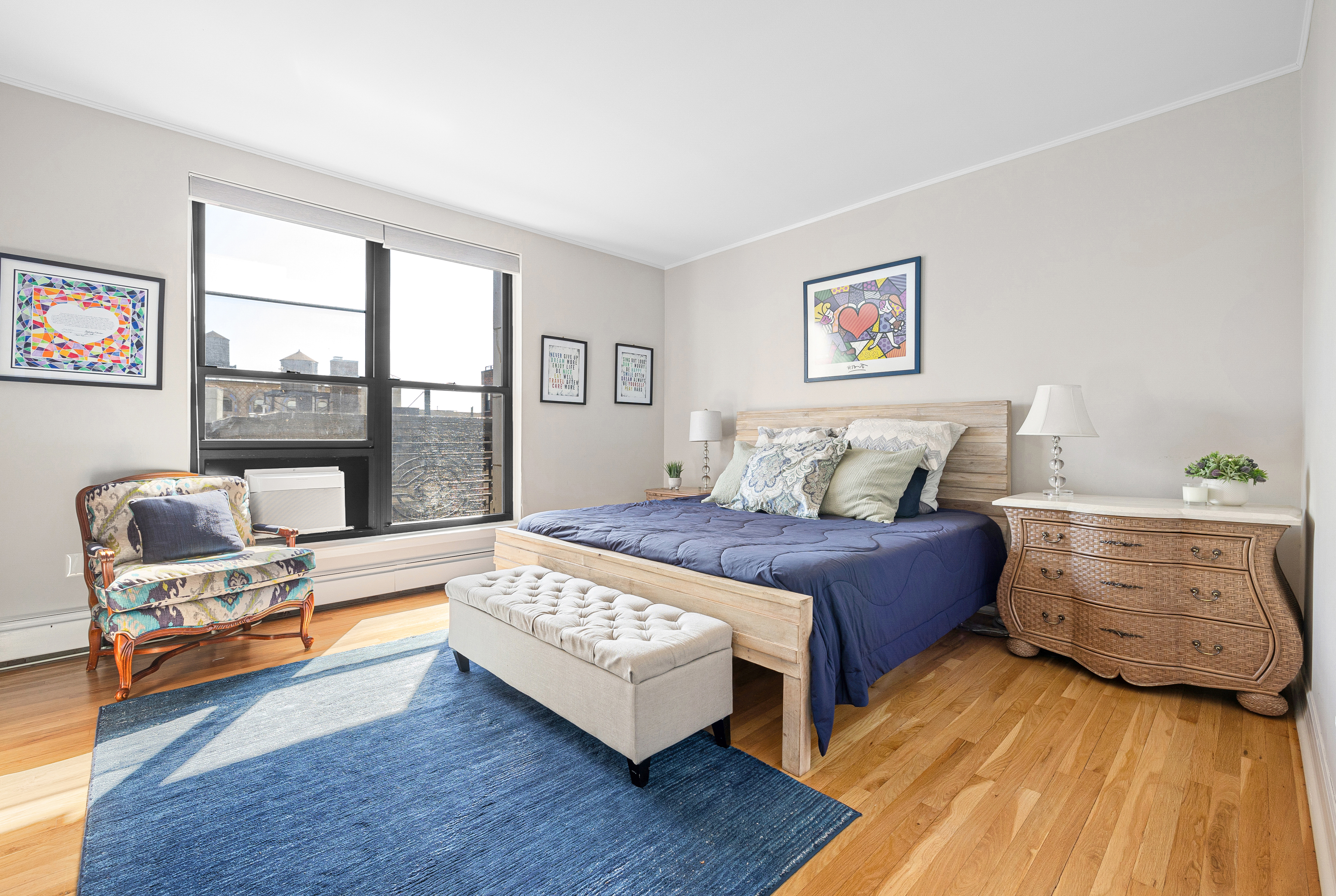 315 West 99th Street, Unit PHA Manhattan, NY 10025 - Photo 8 of 17 a bedroom with a bed and glass window