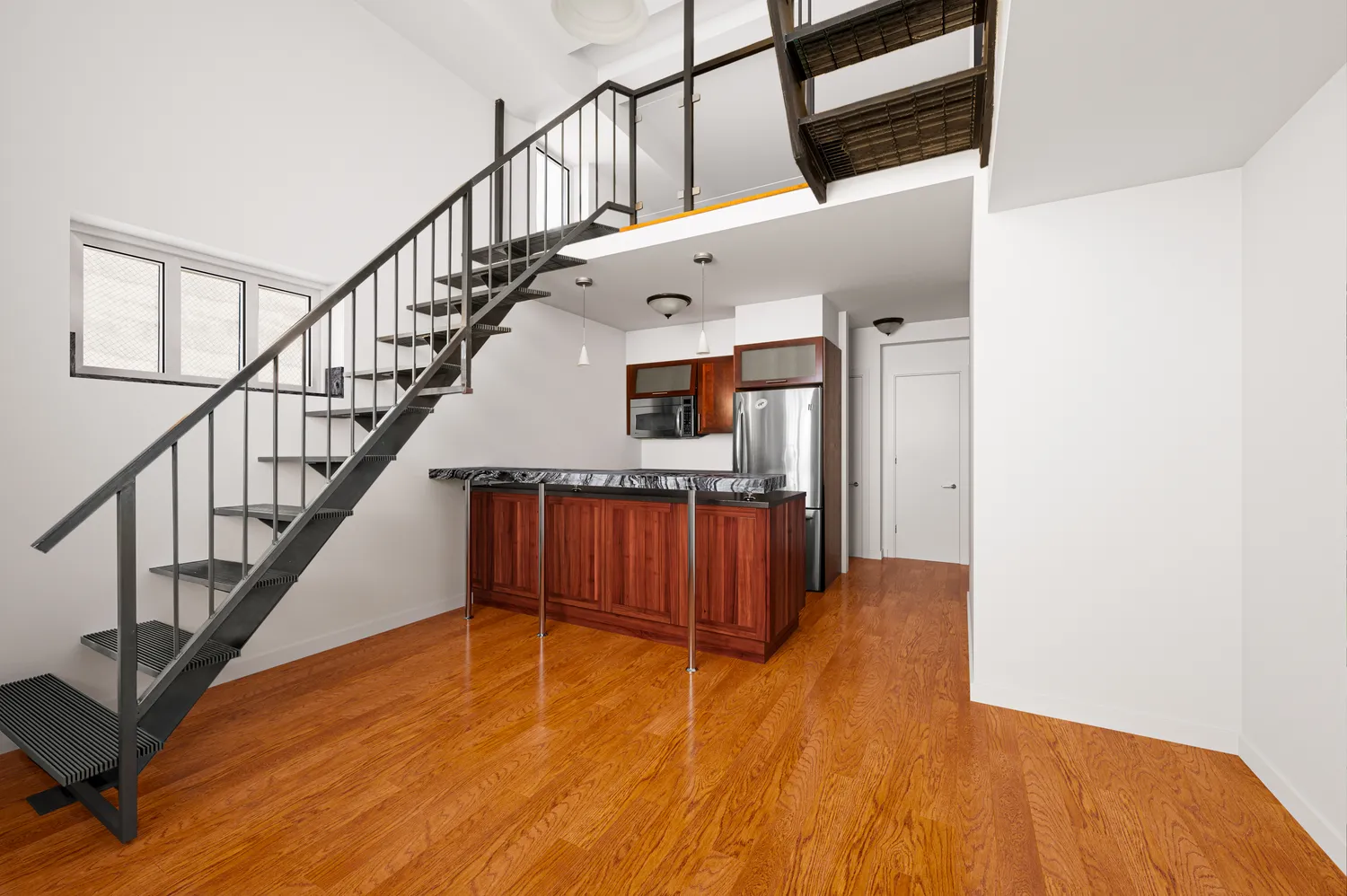 a view of entryway and hall with wooden floor