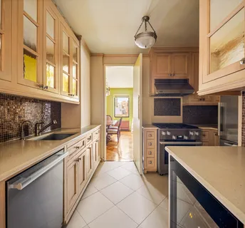 a kitchen with stainless steel appliances a stove a sink and a refrigerator