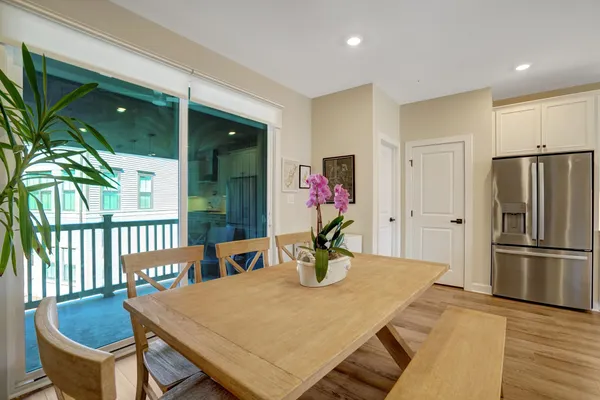 a kitchen with a table chairs and refrigerator