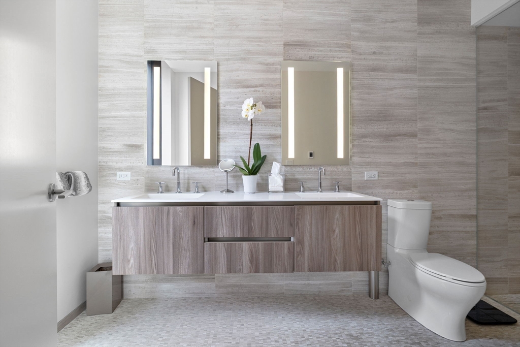 10 Farnsworth Street, Unit 3A Boston, MA 02210 - Photo 17 of 31 a bathroom with a sink a toilet and mirror