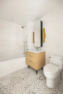 a bathroom with a granite countertop toilet a sink and bathtub