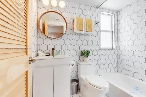 a bathroom with a sink a toilet and a tub