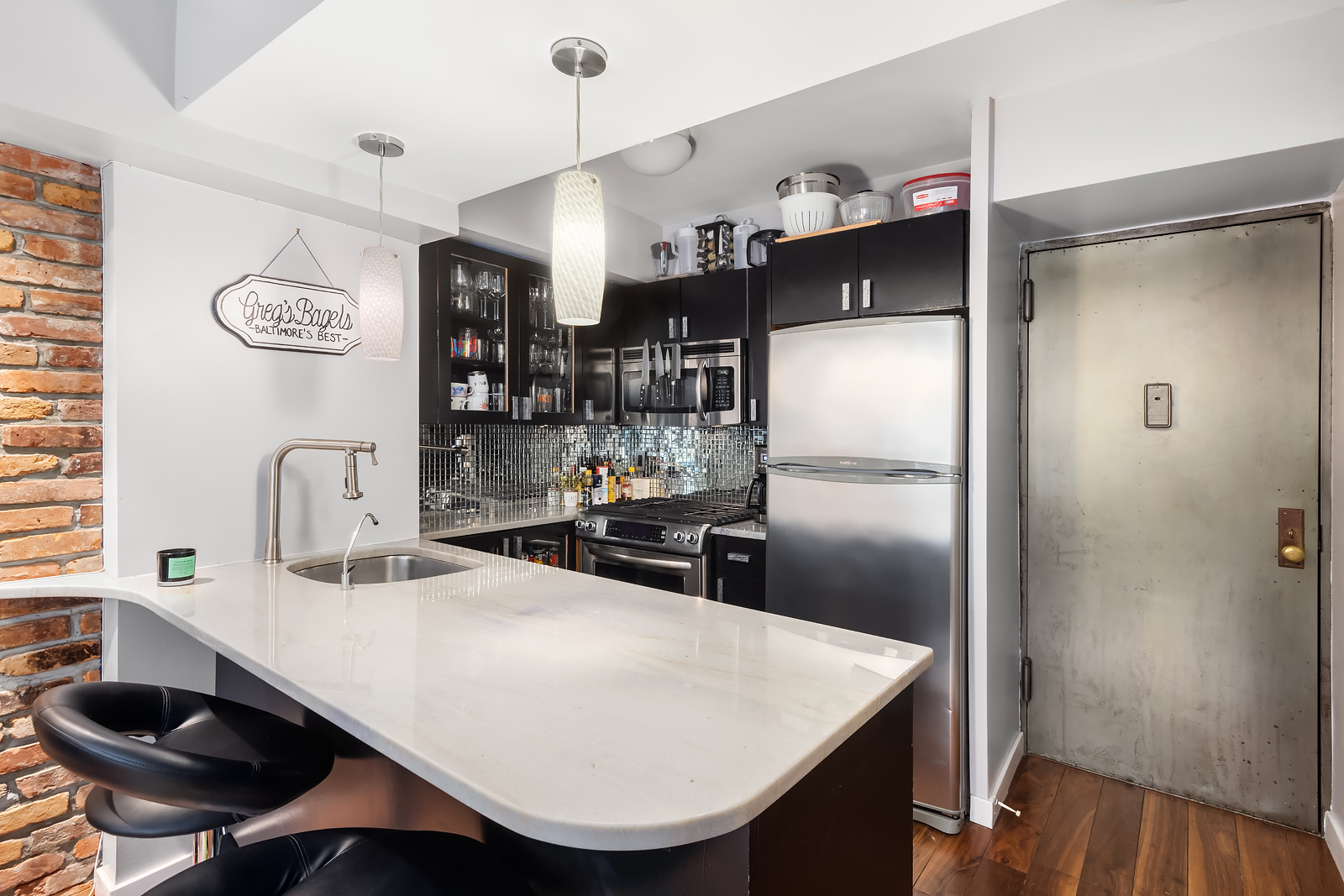 33 Greenwich Avenue, Unit 4E Manhattan, NY 10014 - Photo 5 of 10 a kitchen with stainless steel appliances granite countertop a sink refrigerator and cabinets