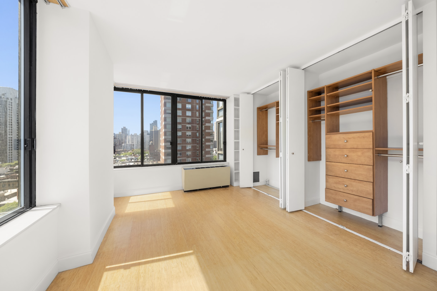 300 East 93rd Street, Unit 18E Manhattan, NY 10128 - Photo 8 of 15 a view of an empty room with a window