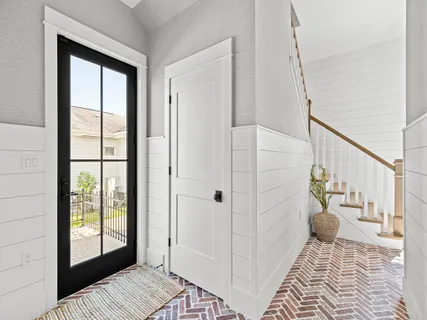 a large kitchen with stainless steel appliances granite countertop a large center island and a wooden floors