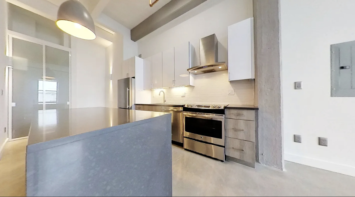 a kitchen with stainless steel appliances a stove a refrigerator and cabinets